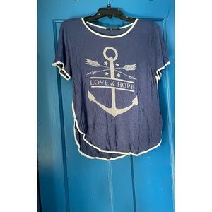 Blue shirt with a dolphin hem featuring an anchor sand the words “love & hope!”